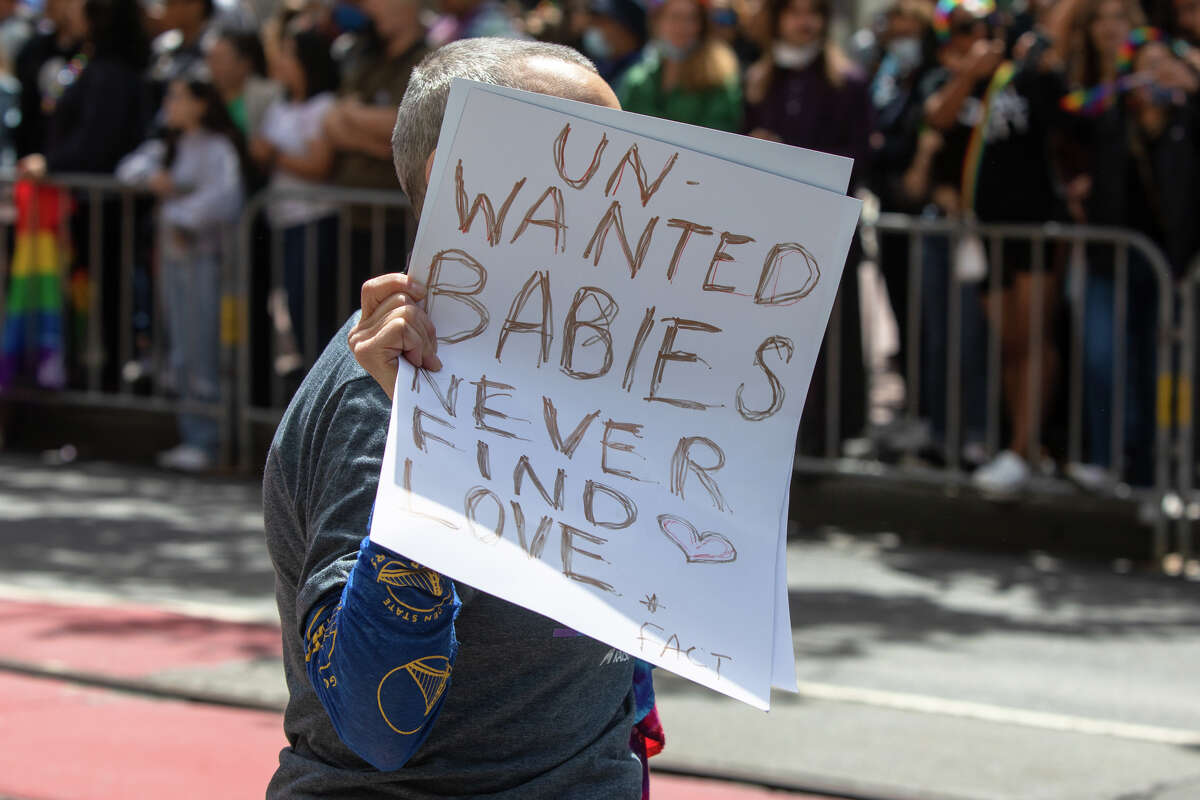 A participant holds a sign during the San Francisco Pride Parade in San Francisco, California on June 26, 2022.