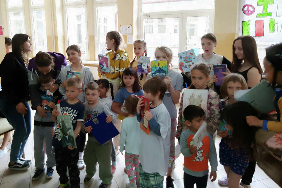 Ukrainian refugee children gather at an old school that is being rebuilt as a refugee center in Boratyn, Poland. Cynthia and Phillip Knapp, a Manistee couple, are helping a nonprofit organization, Poland Welcomes, in retrofitting the building.