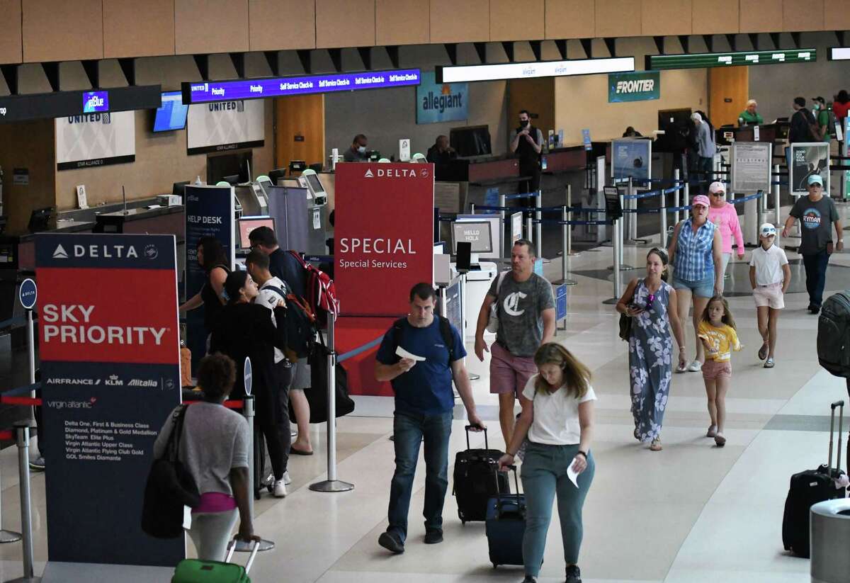 Passengers heads past the ticketing desks at Albany International Airport on Monday, June 27, 2022, in Colonie, N.Y. With 5241 expected departures, Monday was expected to be the airport’s busiest day since the pandemic started.