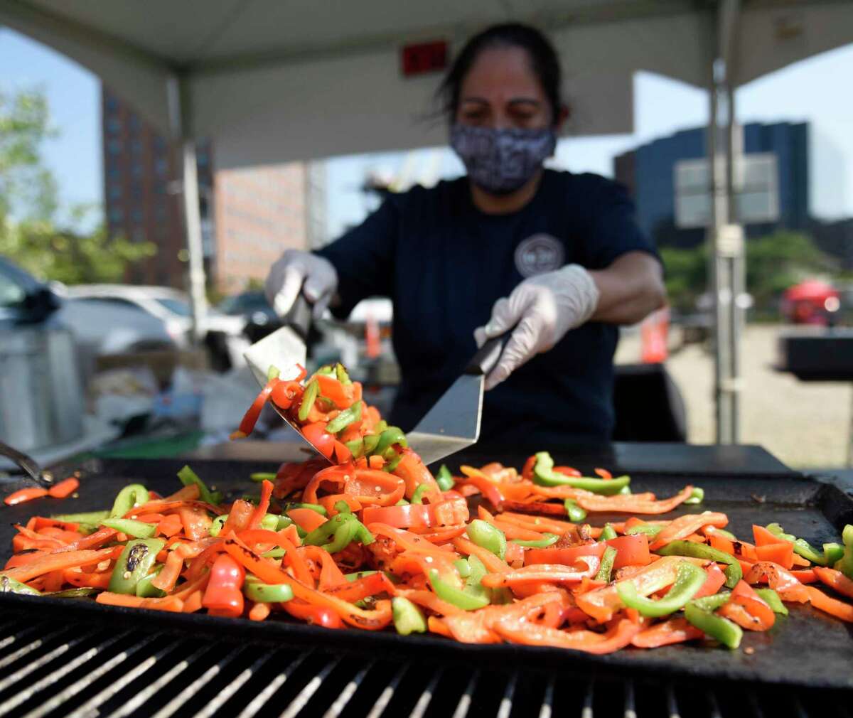 Margarita Capillo, of EB 222 Catering, grills peppers on the opening day of the 2021 Hey Stamford! Food Festival. The Hey Stamford! Food Festival will be back at Mill River Park in August, with cooking demonstrations by celebrity chefs Todd English and Aaron May.