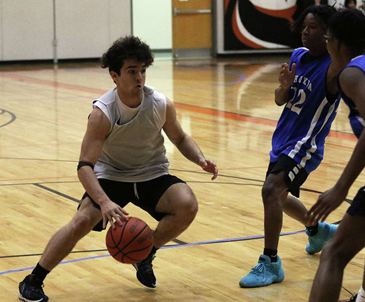 Marquette's Parker Macias (left) takes the ball to the basket against Cahokia defenders on Sunday at the Edwardsville NCAA Live Showcase at Lucco-Jackson Gym in Edwardsville.