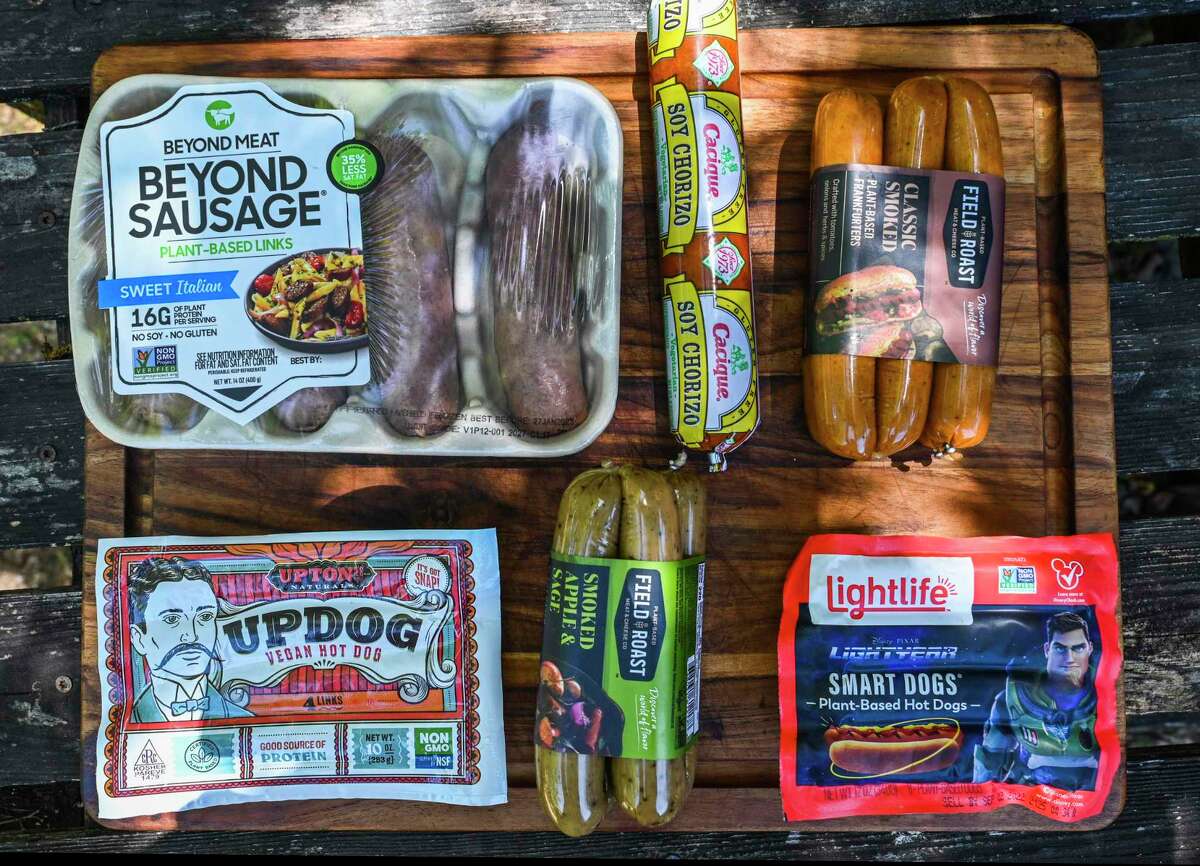 Vegan hot dogs and sausages are available in San Antonio for those that would choose them, including (clockwise from left): Beyond Sausage, soy chorizo, classic smoked vegan frankfurters, Lightife Smart Dogs, smoked apple and sage links and vegan hot dogs from Updog.