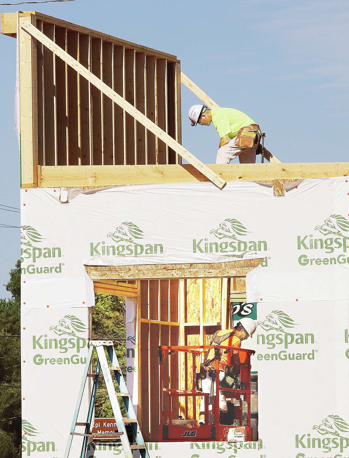 John Badman|The Telegraph Construction workers were inside and on top of the newly framed Scooter's Coffee building under construction at the corner of Route 140 and Prairie Street in Betalto Monday. Work is progressing on the coffee chain's third Illinois location. Drive-thru coffee stands are already open in Glen Carbon and Jerseyville. The national chain has more than 300 locations in 20 states and sells baked from scratch pastries along with its specialty coffee.