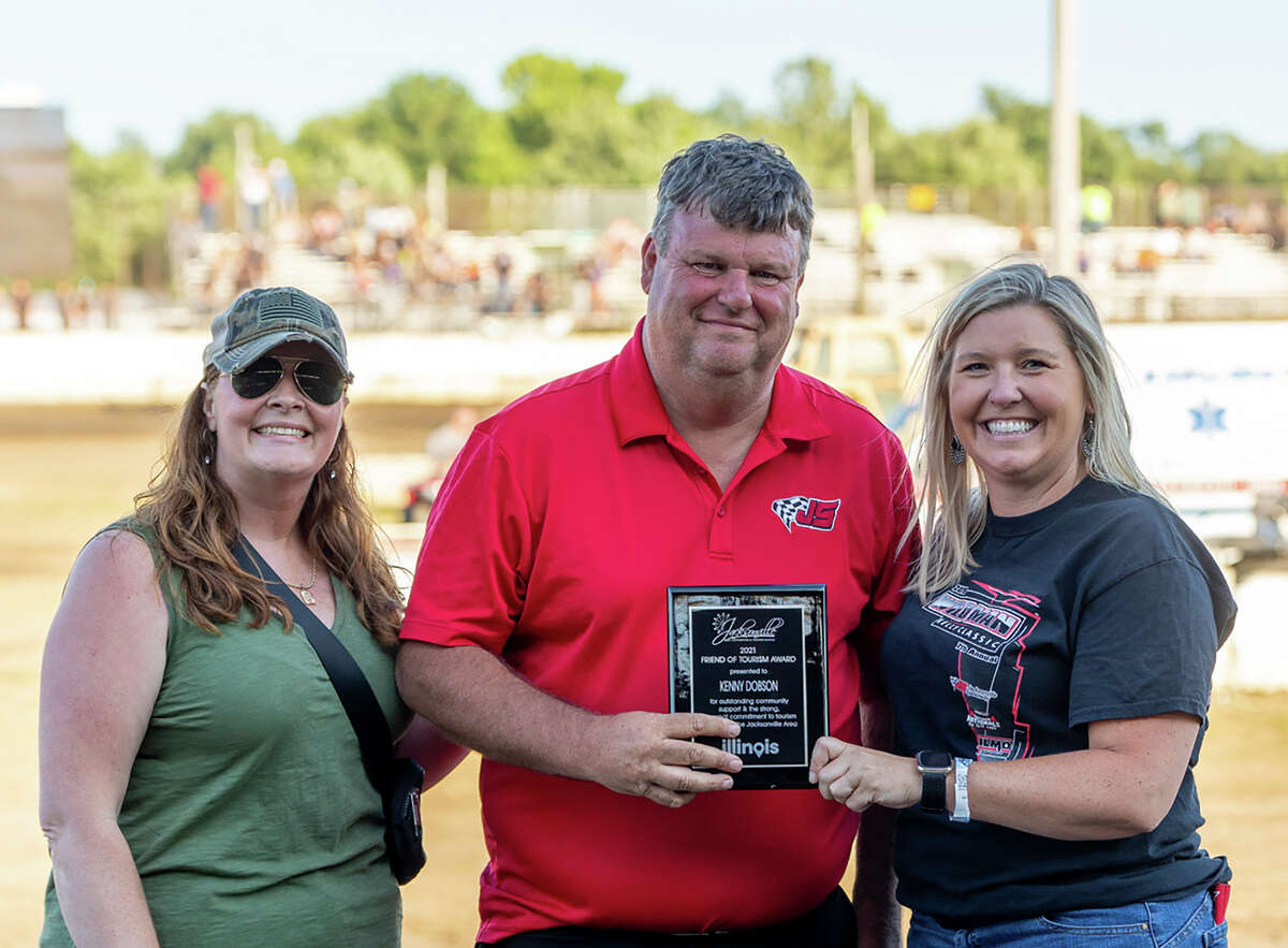 Kenny Dobson (center) of Jacksonville Speedway was recognized Sunday with Jacksonville Area Convention and Visitors Bureau's Friend of Tourism award.
