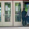 Parents enter Roxbury Elementary School in Stamford, Conn. on Tuesday, Oct. 2, 2018. The Board of Education is looking to add 14 security workers at elementary schools across the district in an effort to beef up safety.