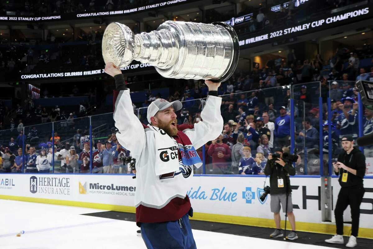 Avalanche defenseman Devon Toews, a Quinnipiac alum and former Bridgeport Sound Tiger, hoists the Stanley Cup after Colorado beat the Lightning 2-1 on Game 6 on Sunday night in Tampa, Fla.
