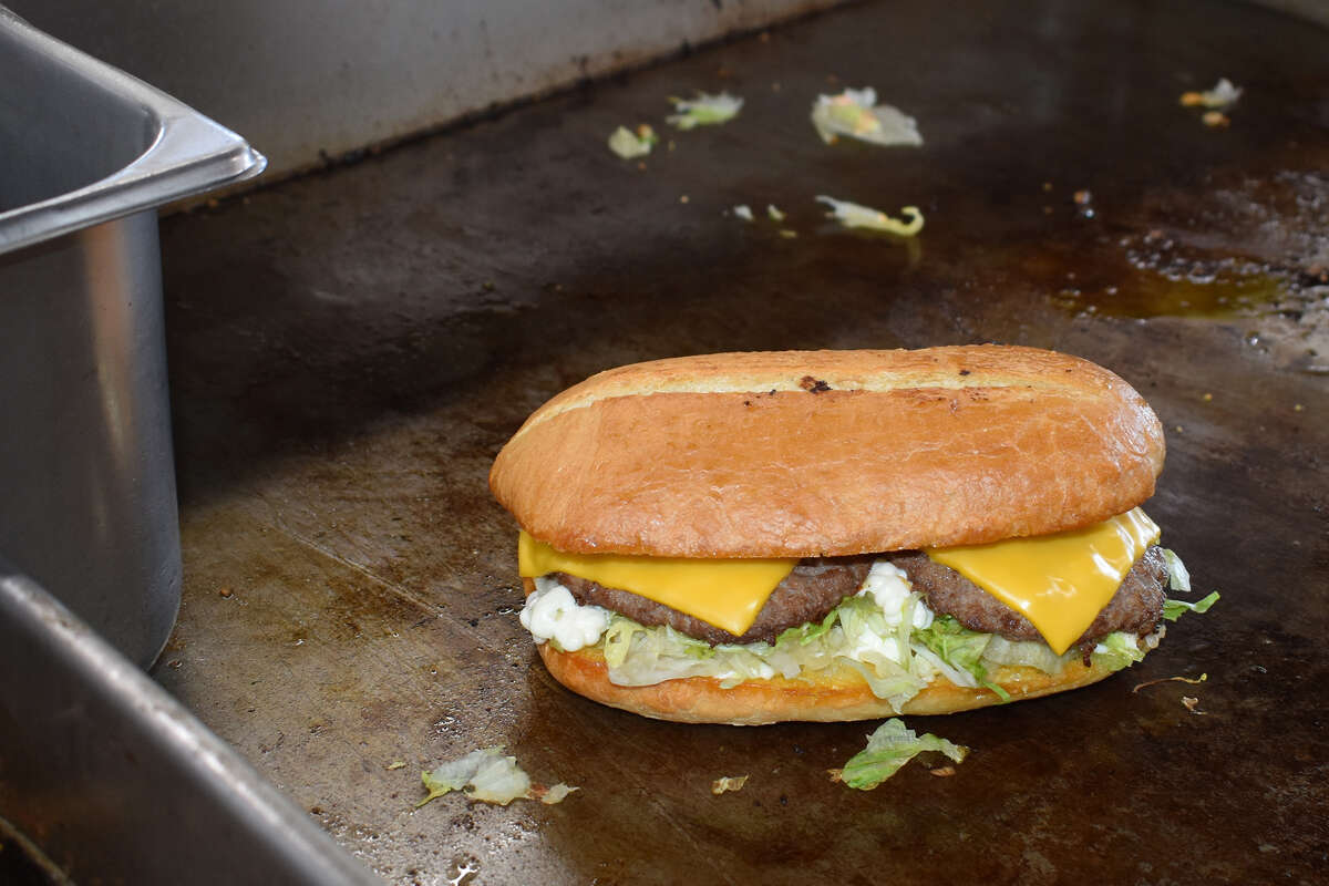 Sitting on the grill and ready to go, the famous French burger at Andre's Drive-In in Bakersfield is the 65-year-old fast food icon's flagship meal. 