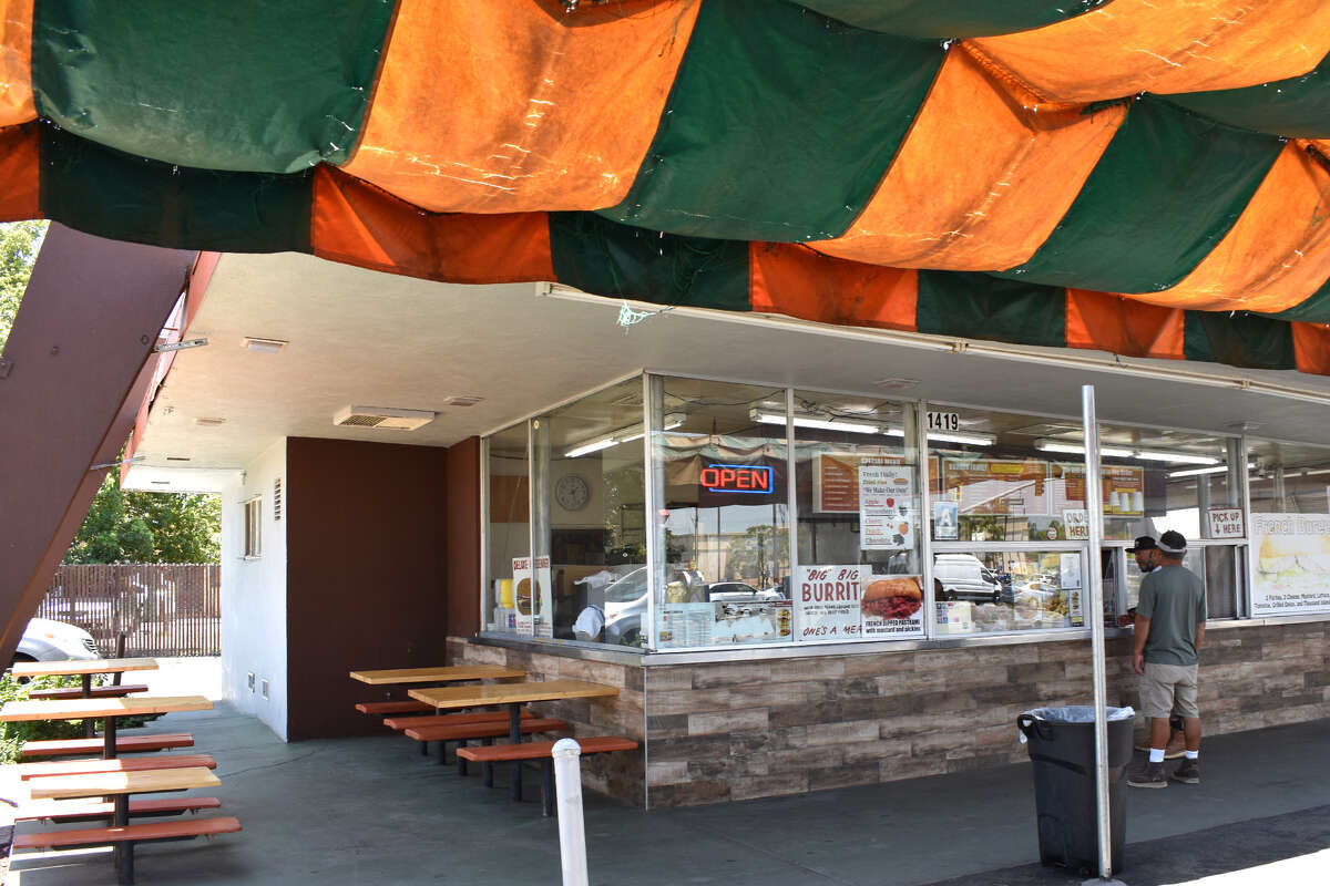 Under the striped awning at Andre's Drive-In are some shady spots to enjoy a meal and think on the long, storied history of a still-going California fast food institution. 