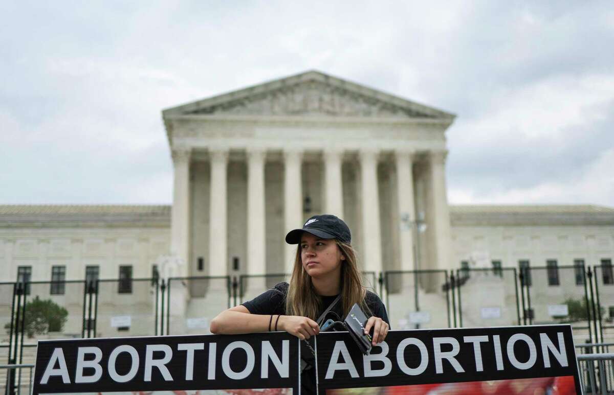 An anti-abortion activist protests outside the U.S. Supreme Court on Monday.
