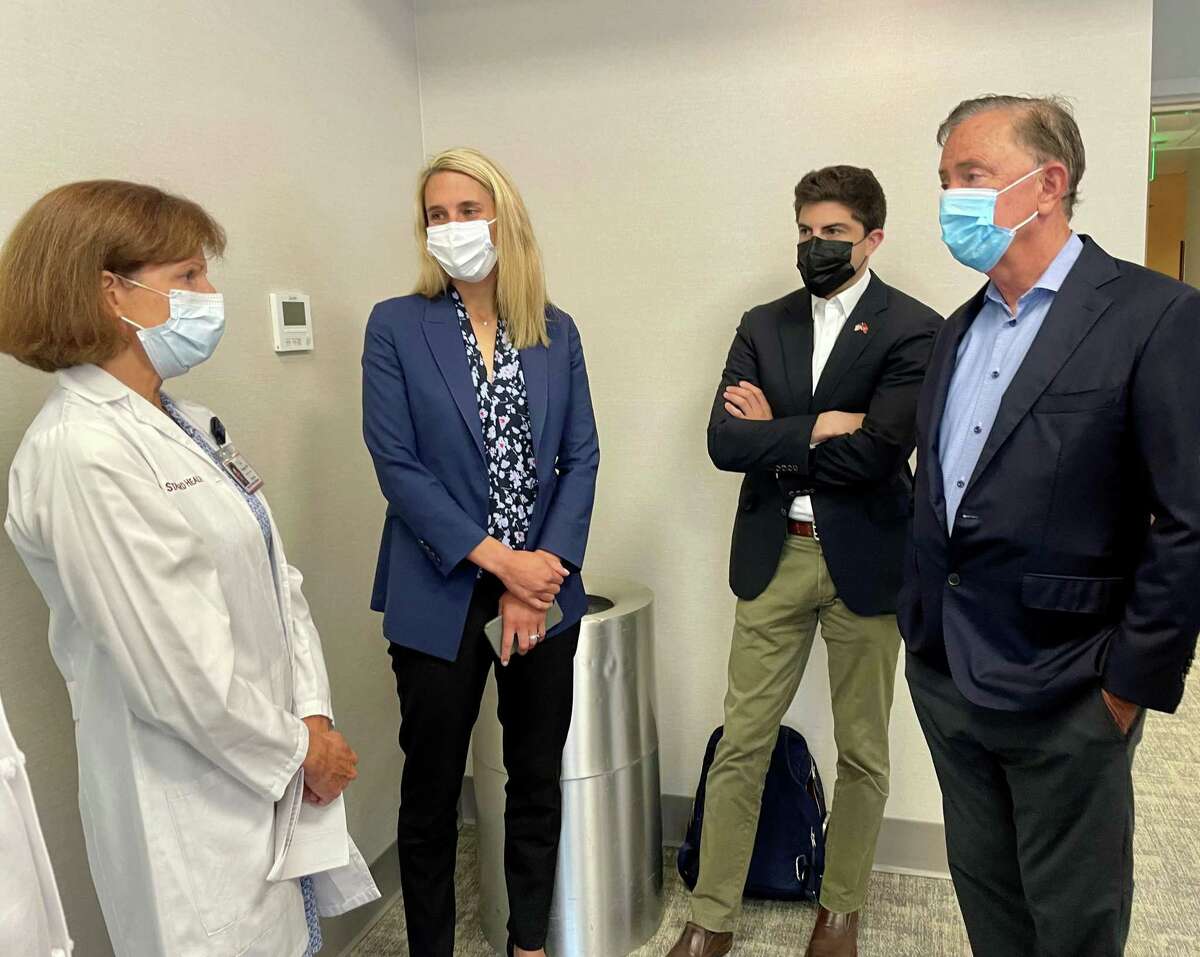 Gov. Ned Lamont speaks with Dr. Carol Fucigna, interim chair of the Department of OB/GYN at Stamford Health, during a visit to the hospital complex on June 27, 2022, three days after the U.S. Supreme Court's decision to overrule Roe v. Wade, as Stamford Mayor Caroline Simmons and State Rep. Matt Blumenthal, D-Stamford, look on.
