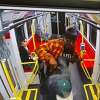 Nesta Bowen (in orange) attacks a man who appears to be Javon Green with what looks like a knife on a Muni train in a still from surveillance video.