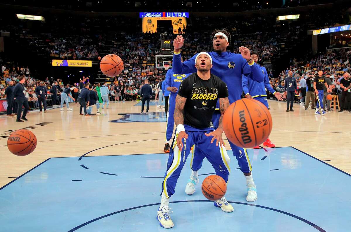 Gary Payton II (0) and Kevon Looney (5) during warmups before the Golden State Warriors played the Memphis Grizzlies in Game 1 of the second round of the NBA Playoffs at Fedex Forum in Memphis, Tenn., on Sunday, May 1, 2022.