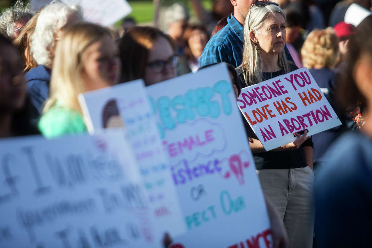 FILE - Angie Kelleher of Midland holds a sign as hundreds attend a rally in support of reproductive rights in reaction to the U.S. Supreme Court's decision to overturn Roe v. Wade Monday, June 27, 2022, in front of the Midland County Courthouse.