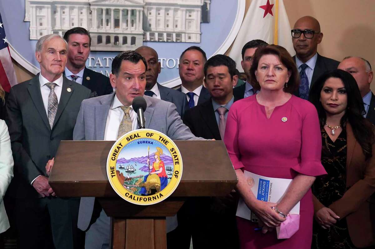 Assembly Speaker Anthony Rendon, D-Lakewood, at podium, and state Senate President Pro Tempore Toni Atkins, D-San Diego, are accompanied by other lawmakers at a gun control news conference in Sacramento, Calif., on May 25, 2022.