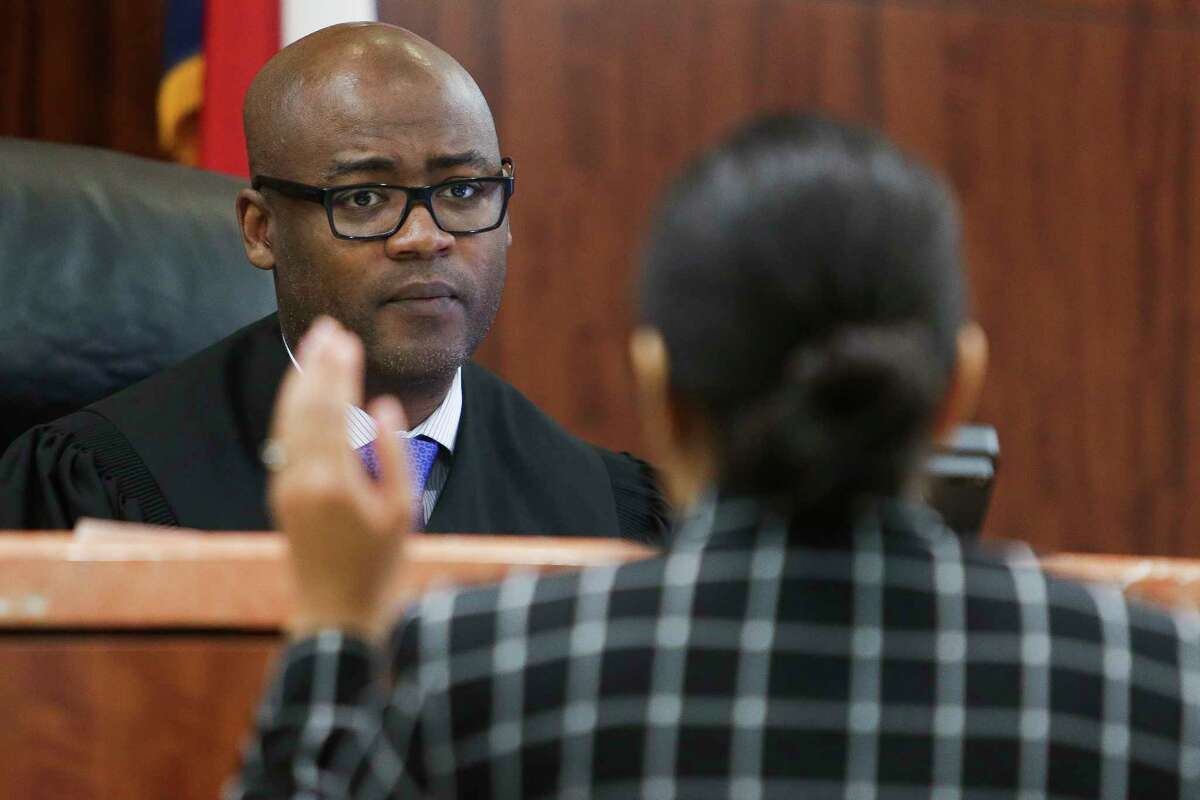 Judge Darrell Jordan, left, goes through his docket at the Harris County Criminal Courthouse Tuesday, May 9, 2017 in Houston. Jordan has testified against other judges in Harris County in a federal lawsuit claiming that by setting high bonds for poor people accused of low-level offenses and pose no danger or flight risk, the system is set up to jail people merely because they are poor. Judge Jordan has abolished the practice in his own courtroom.