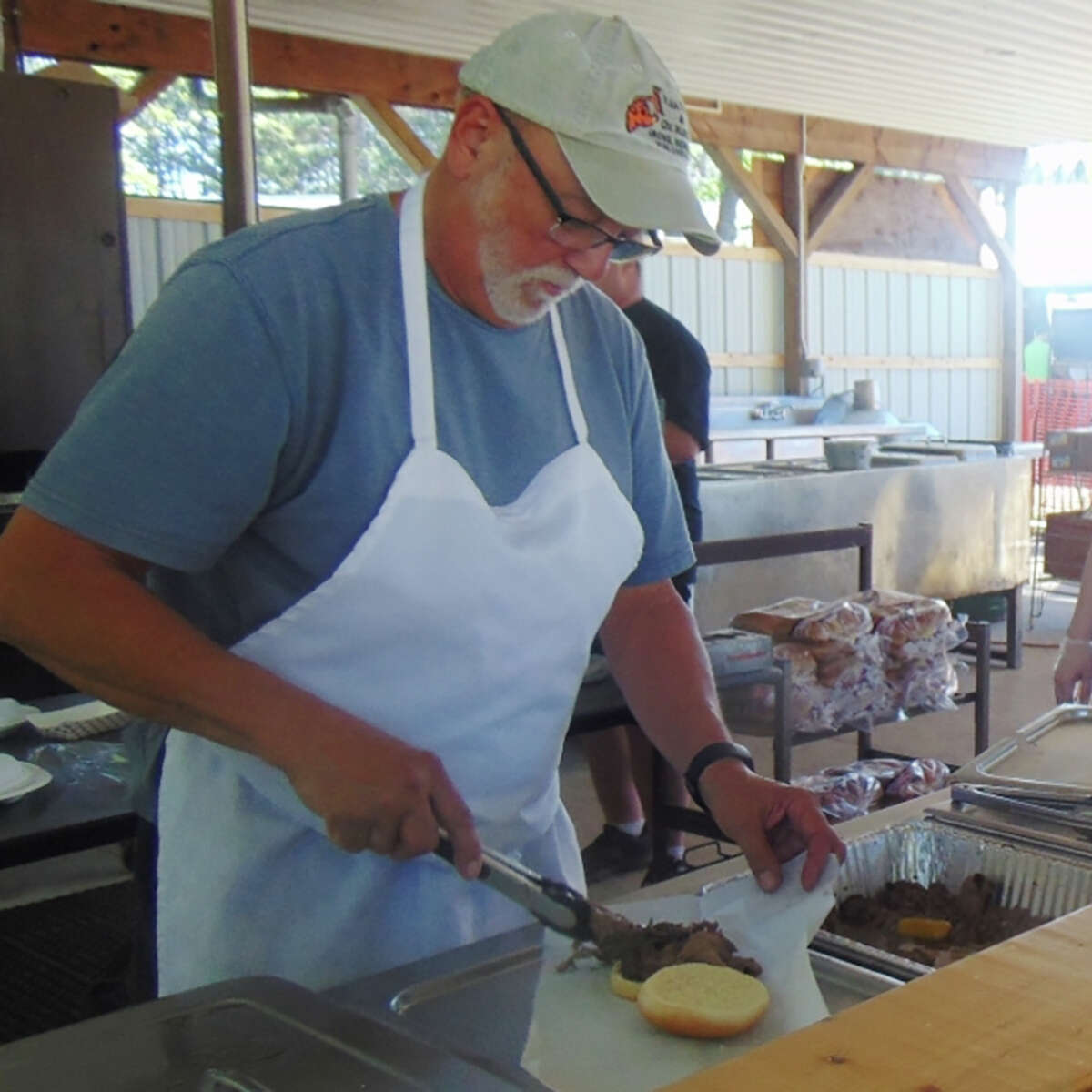 After being canceled the past two years, the annual Irons Flea Roast & Ox Market made a big comeback for its 46th year. Above, volunteers with IATA serve up the traditional flea burger, a roast beef sandwich. 