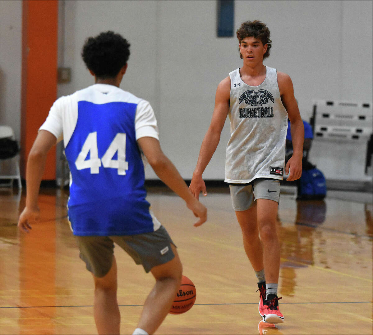 Father McGivney's Evan Schrage brings the ball up the court during a game against Marquette Catholic at the NCAA Live Showcase at Edwardsville High School on Saturday.