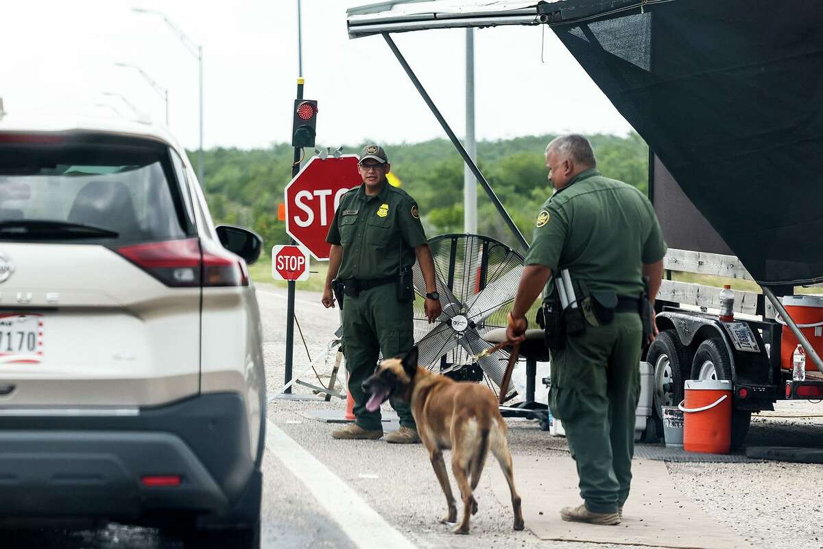 Border Patrol officers inspect a line of cars in on US-90 in Uvalde, Texas on Tuesday, May 31, 2022. A new U.S. Customs and Border Protection Inspection Station Check Point is currently under construction. (Lola Gomez/Dallas Morning News/TNS)