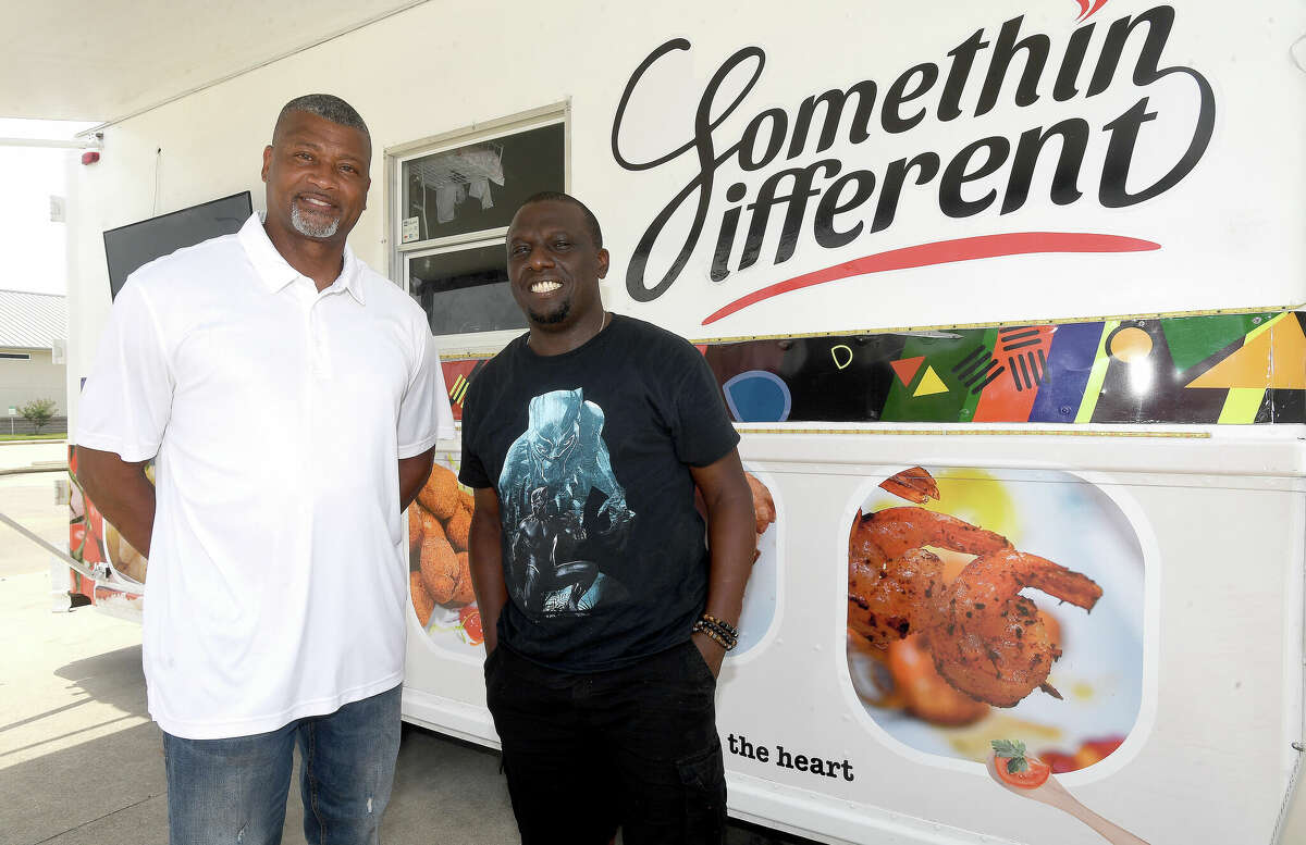 Port Arthur Rotary Club President Arthur Thomas (left) stands with Somethin Different food truck owner Ebun Roberts, which is among the local vendors joining in this Saturday's Taste of Summer fundraiser at the Carl Parker Center. Photo made Tuesday, June 28, 2022. Kim Brent/The Enterprise
