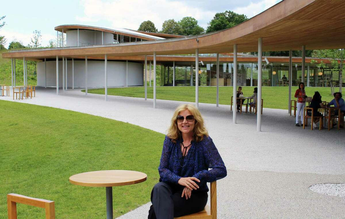 Sharon Prince, president of Grace Farms Foundation, sitting in front of the iconic Grace Farms building.