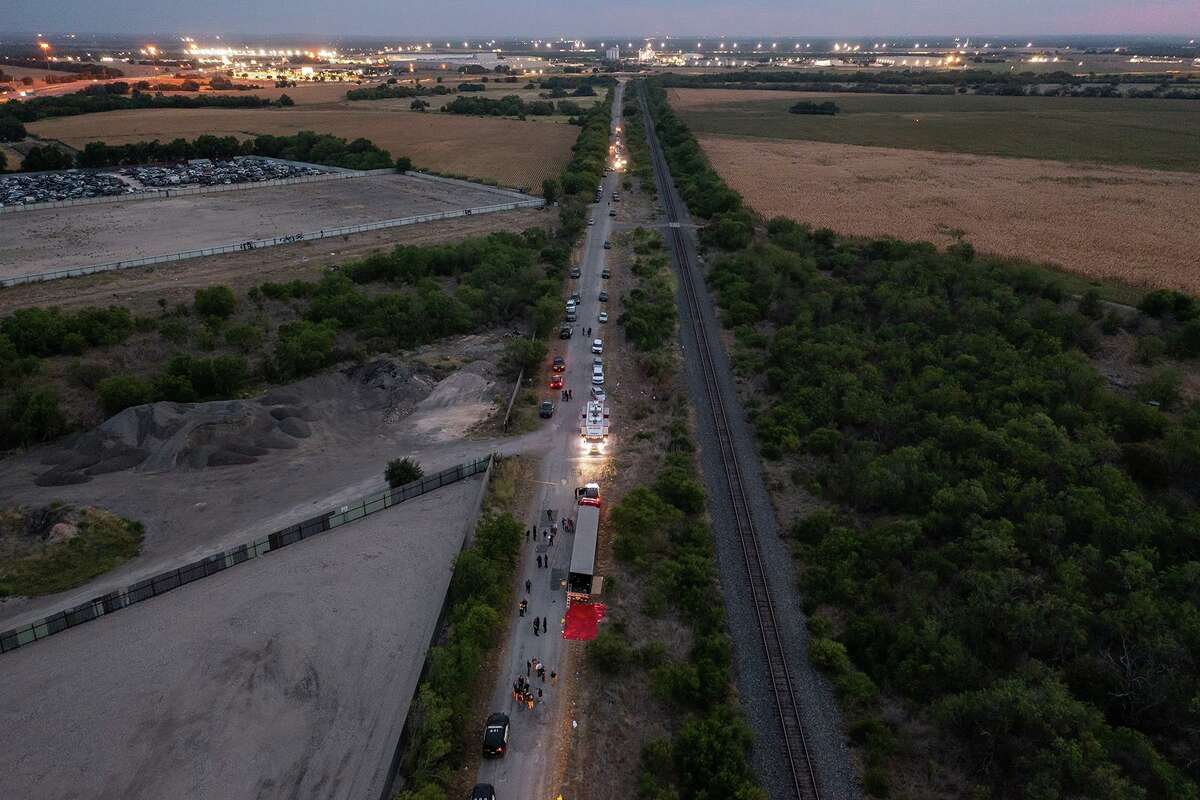 In this aerial view, members of law enforcement investigate a tractor-trailer on June 27, 2022, in San Antonio, Texas. According to reports, at least 46 people, who are believed migrant workers from Mexico, were found dead in the trailer, a figure that rose to 50 on June 28. (Jordan Vonderhaar/Getty Images/TNS)