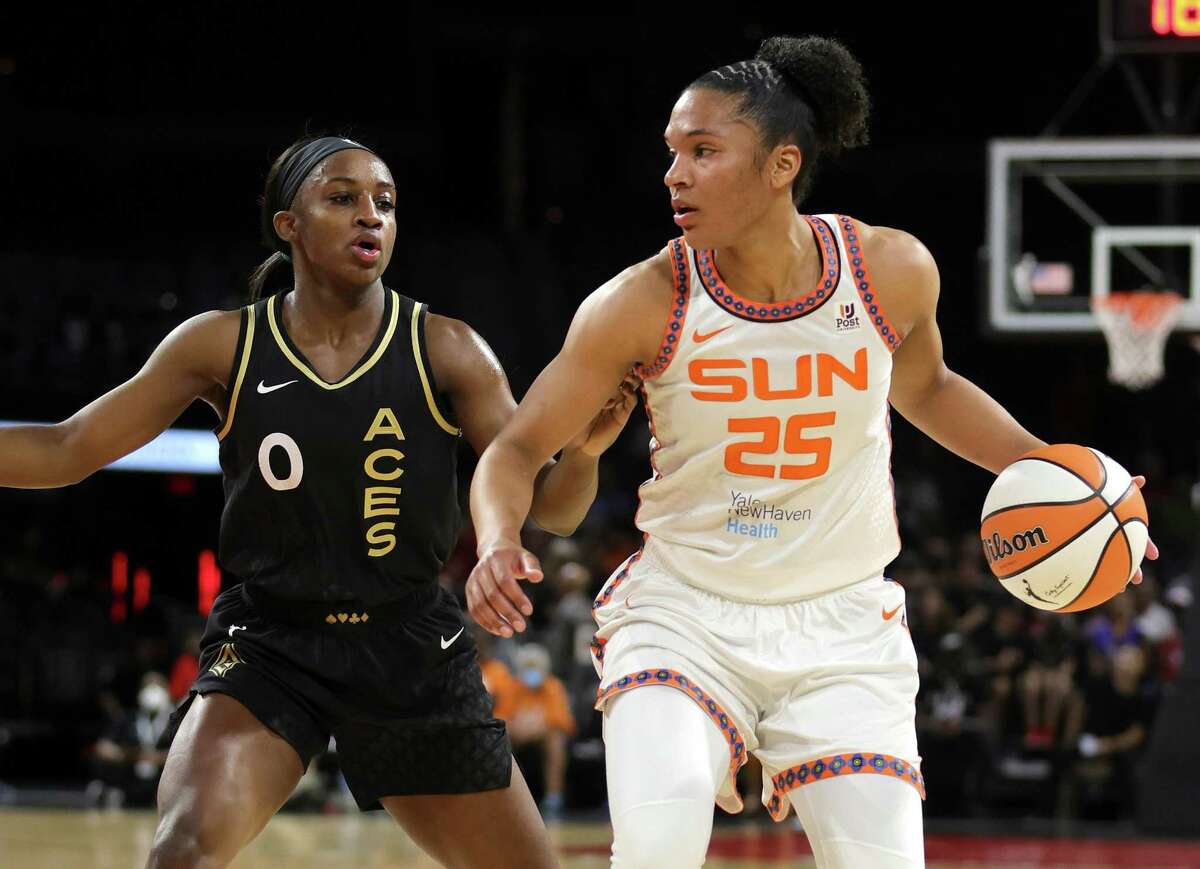 Alyssa Thomas (25) of the Connecticut Sun is guarded by Jackie Young (0) of the Las Vegas Aces during their game at Michelob ULTRA Arena on June 2, 2022 in Las Vegas. The Sun defeated the Aces 97-90. Thomas was named to her third All-Star team on Tuesday.