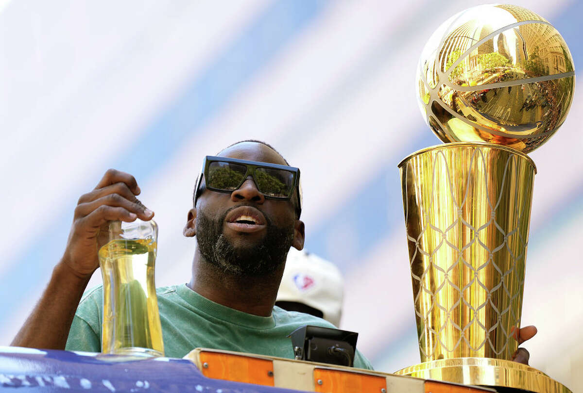 Draymond Green of the Golden State Warriors celebrates with the NBA Championship Trophy during the Golden State Warriors Victory Parade on June 20, 202.