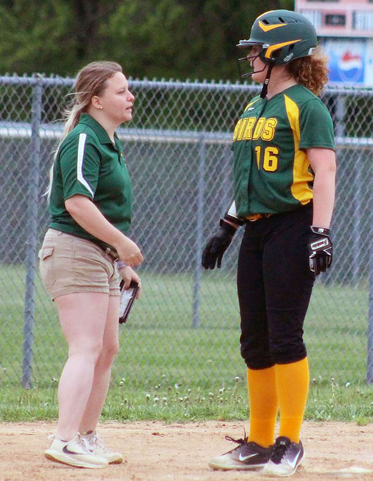 Coach Amanda Edwards, left, talks with Southwestern player Whitney Keith during a 2019 game. Edwards, who was assistant coach six seasons, has been named the new head softball coach at Southwestern, replacing Peg Mitchell, who retired after 12 seasons.