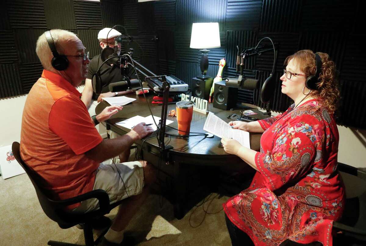 Leah Lamp, right, talks with producer Philip Sinqefield across from Steve Meeker about her ideas for a future episode of their podcast, Remnant Stew, Saturday, June 25, 2022, in Conroe. Lamp, along with Meeker, a retired Willis ISD teacher, started the podcast about weird and interesting things in history.