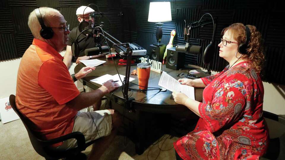 Leah Lamp, right, talks with producer Philip Sinqefield across from Steve Meeker about her ideas for a future episode of their podcast, Remnant Stew, Saturday, June 25, 2022, in Conroe. Lamp, along with Meeker, a retired Willis ISD teacher, started the podcast about weird and interesting things in history.