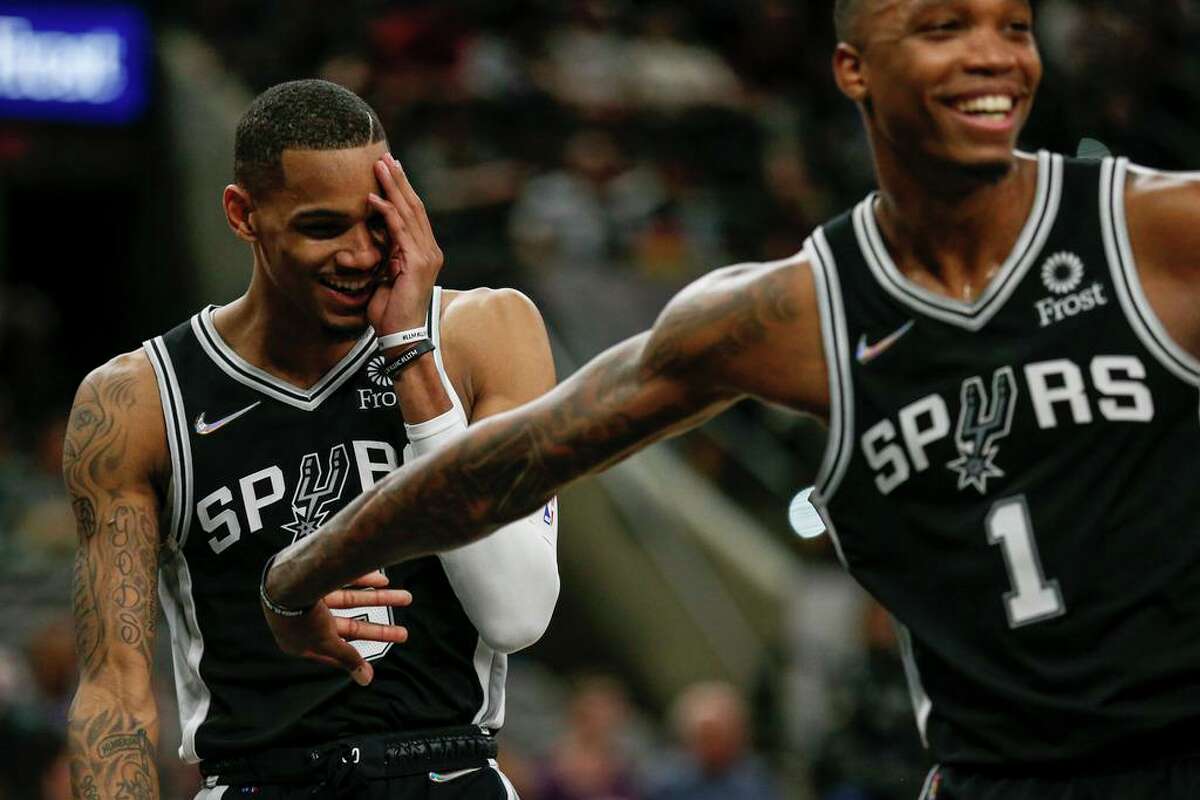 San Antonio Spurs guard Dejounte Murray (5) and San Antonio Spurs guard Lonnie Walker IV (1) joke around during the first half against the Sacramento Kings at AT&T Center, Thursday, March 3, 2022 in San Antonio, Texas.