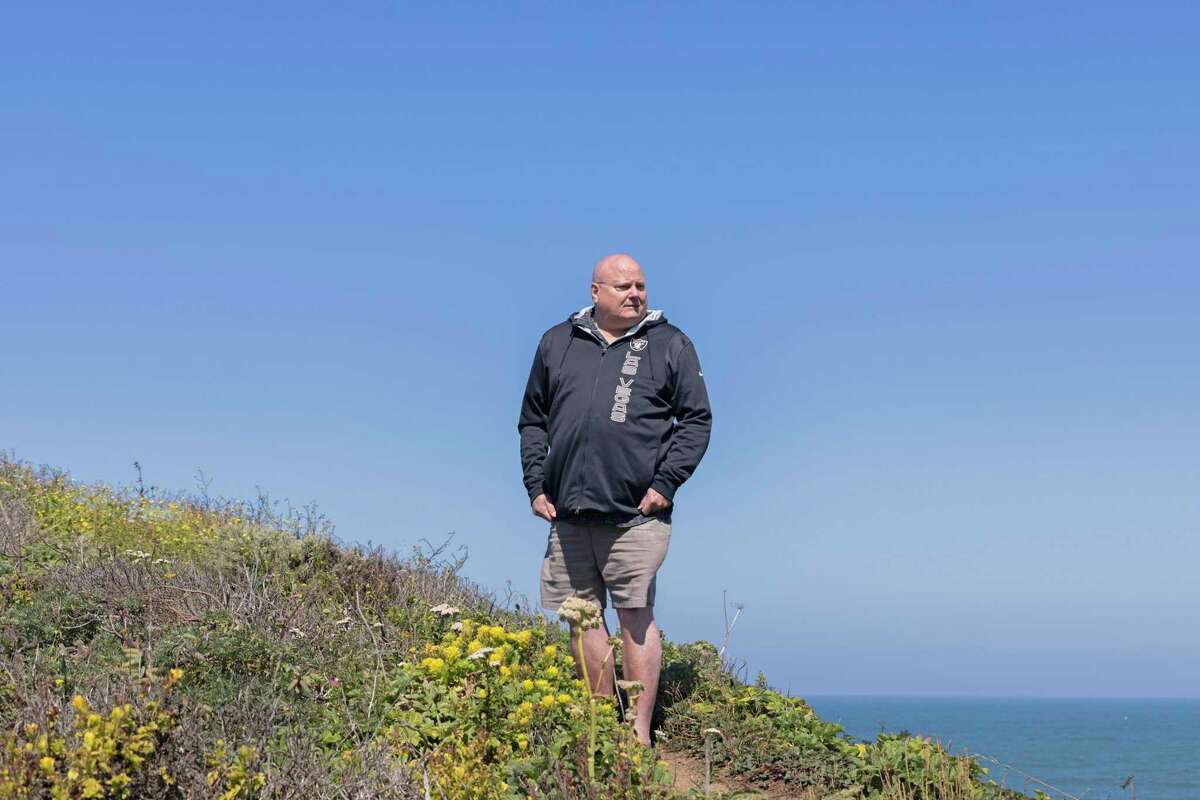Dan Moss stands along Highway 1 near Devil’s Slide in San Mateo County. His son Richard Moss died after driving off the road there in 2017. Since his son’s death, Dan has been advocating and demanding officials make the road safer.