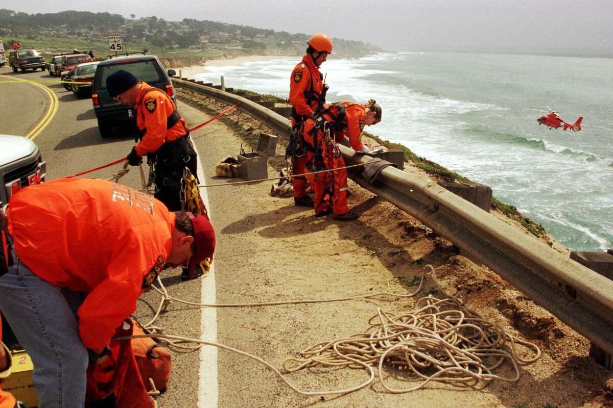 DEVIL'S SLIDE 01/C/22APR98/MN/CG --- San Mateo County Sherriff's Rescue team members check the cliffside on Devil's Slide where a rental van went over the edge, ejecting the driver who was not found after witnesses said they saw him in the water. A U.S. Coast Guard helicopter and ship searched the water for several hours after the accident but could find no one in the water. (CHRONICLE PHOTO BY CARLOS AVILA GONZALEZ)