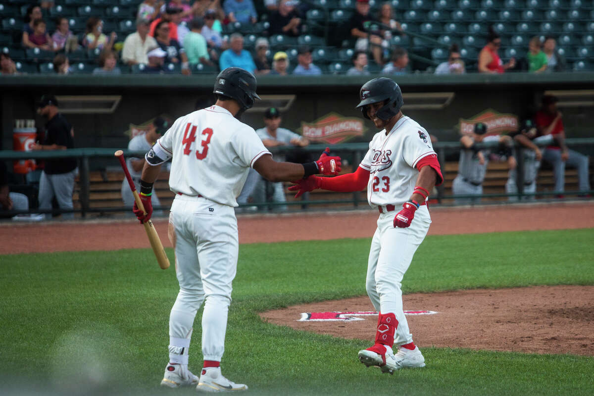 Great Lakes Loons outfielder Ismael Alcantara, right, high-fives Alex De Jesus, left, after hitting a home run during a game against the Dayton Dragons Tuesday, June 28, 2022 at Dow Diamond.