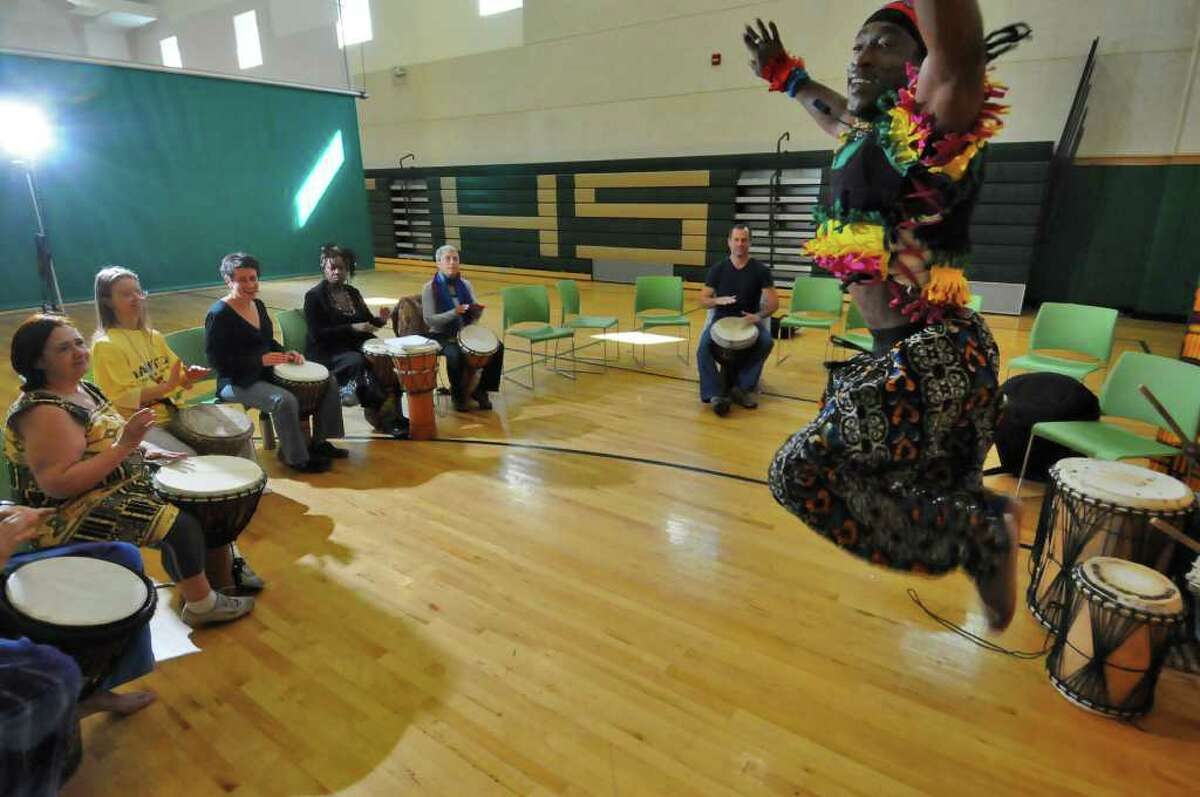 Caro Diallo of Senegal, West Africa demonstrates a blend of traditional dances from West Africa during the two day "Abene to Albany" African Dance and Drum Festival at Green Tech High Charter School in Albany, NY on Sunday October 3, 2010 in Albany, NY. He taught dance workshops. Leading the djembe (drum) workshop is Fode Bangoura of Guinea. ( Philip Kamrass / Times Union )