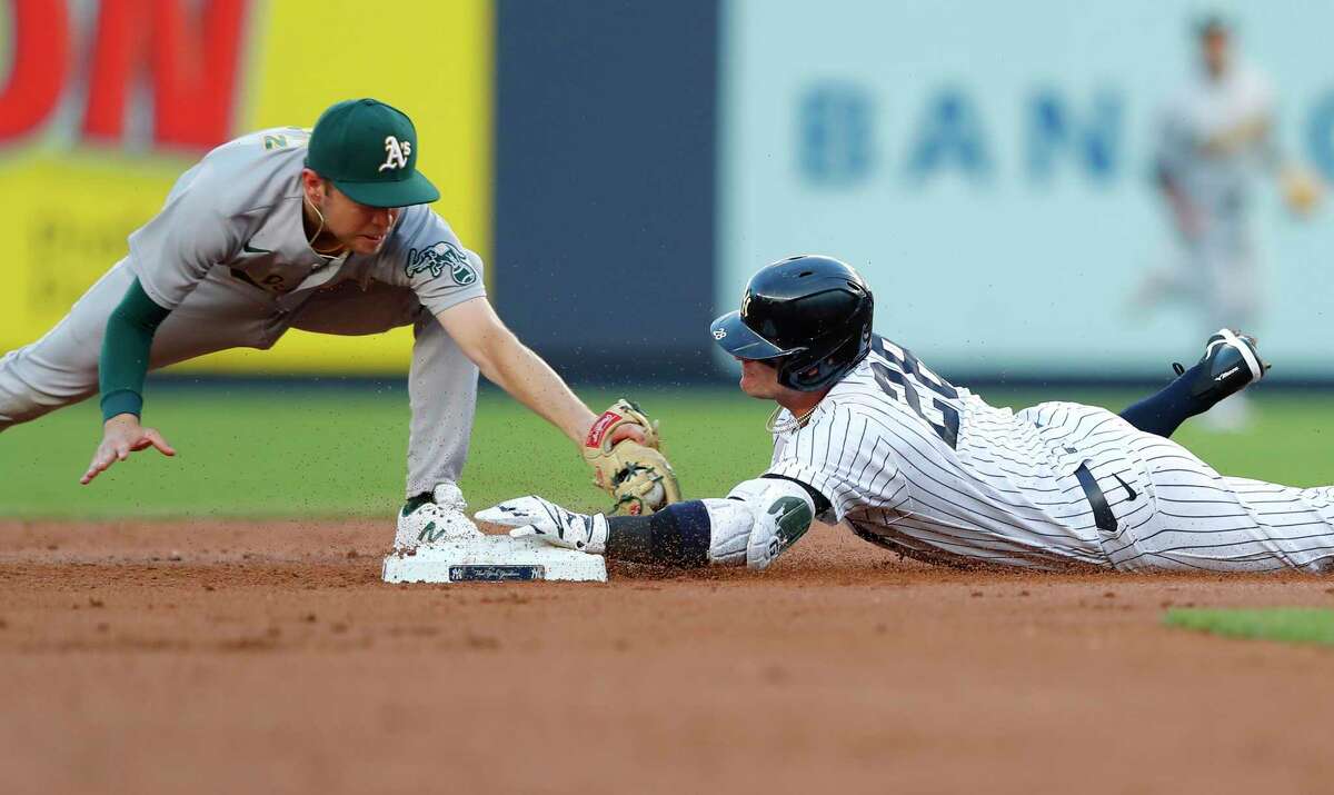 New York Yankees' Josh Donaldson (28) beats the tag of Oakland Athletics second baseman Nick Allen on a double during the first inning of a baseball game Tuesday, June 28, 2022, in New York. (AP Photo/Noah K. Murray)