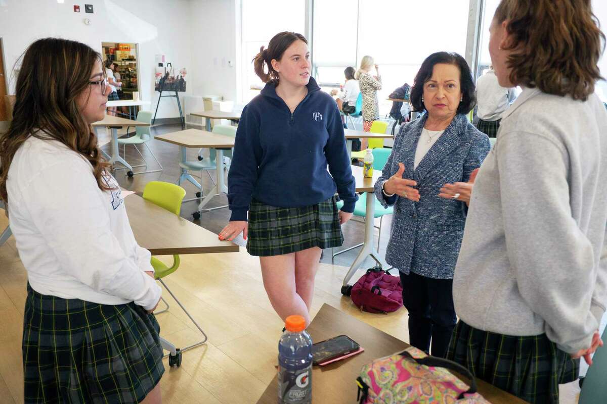 Mary Anne Vigliante, third from left, the Head of School at Academy of the Holy Names, talks with seniors, Ashley Graff, left, Ursula Follert, second from left, and Tanner Poissant in the student commons on Monday, April 11, 2022, in Albany, N.Y. (Paul Buckowski/Times Union)
