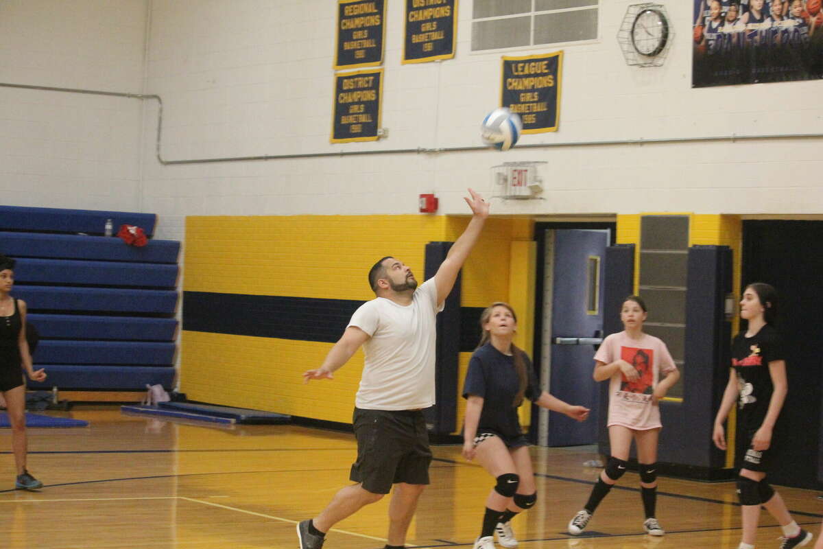 Baldwin volleyball coach Duane Roberts (left) works with his players during a camp session on Monday.