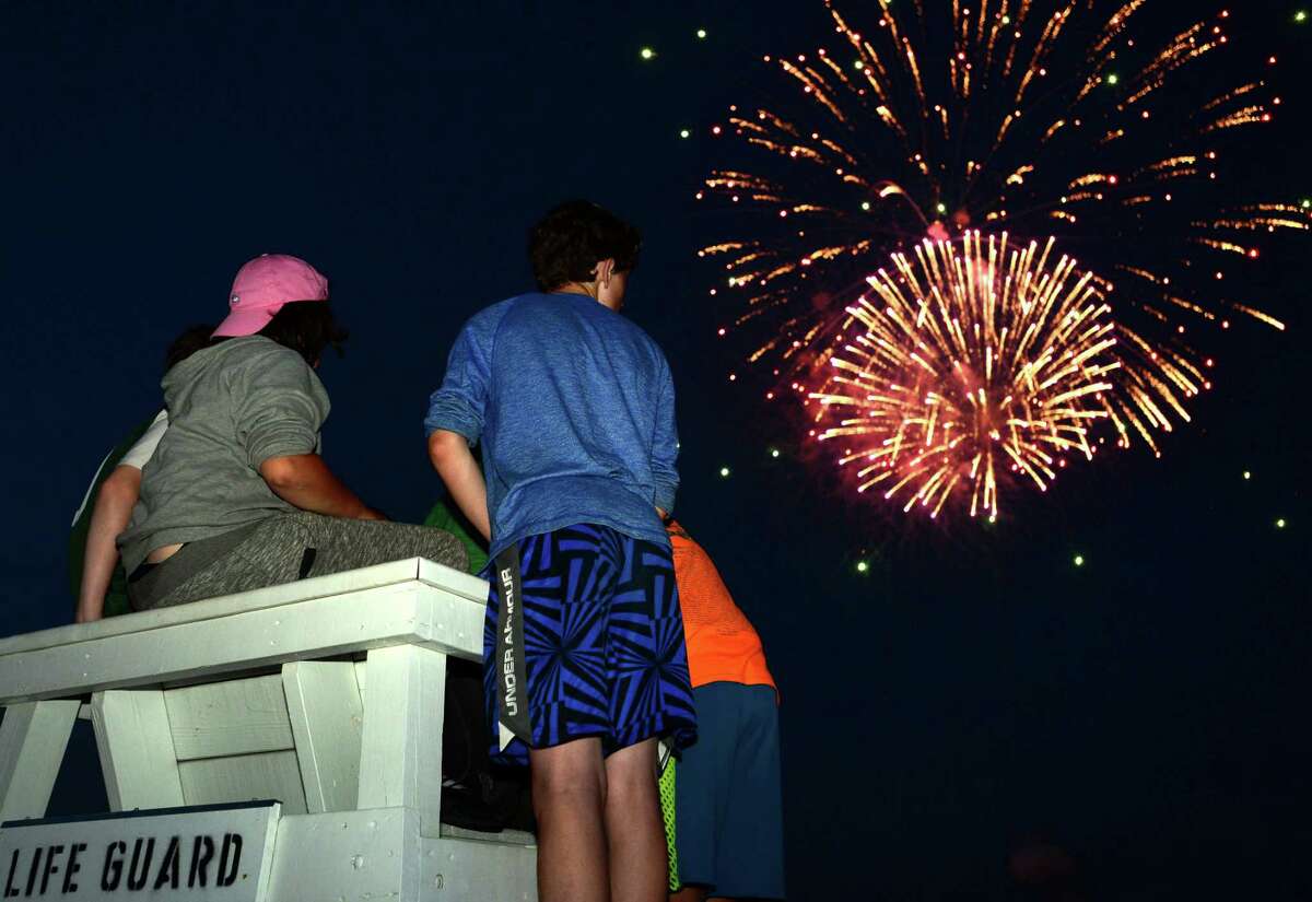 Locals gather for the annual fireworks show at Calf Pasture Beach on Wednesday, July 3, 2019, in Norwalk, Conn.