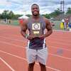 Gary Moore Jr. of Hillhouse holds the first place plaque for winning the discus at the New England track meet.