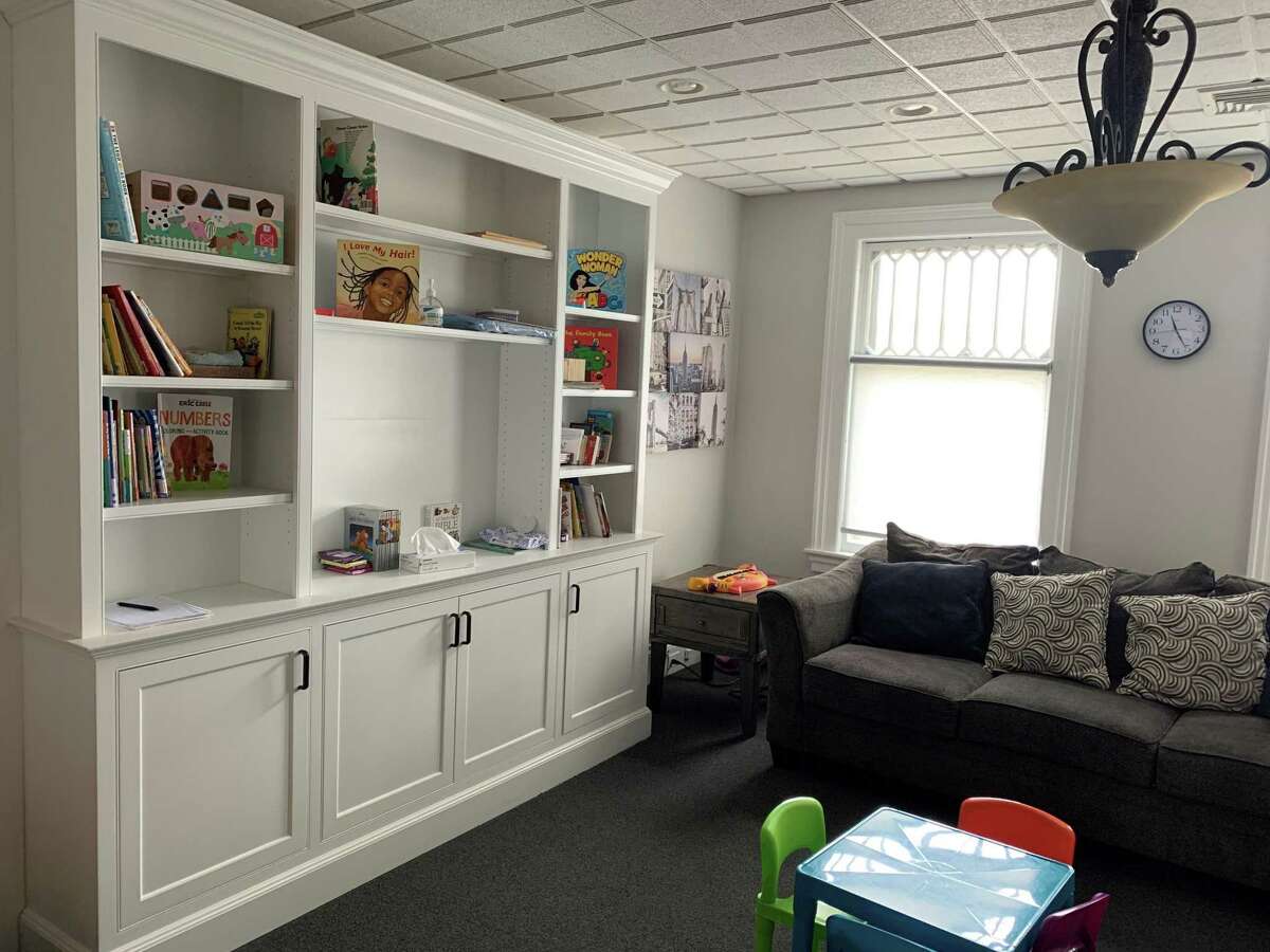 The center features eight visiting rooms like this one, full of books and toys for children.