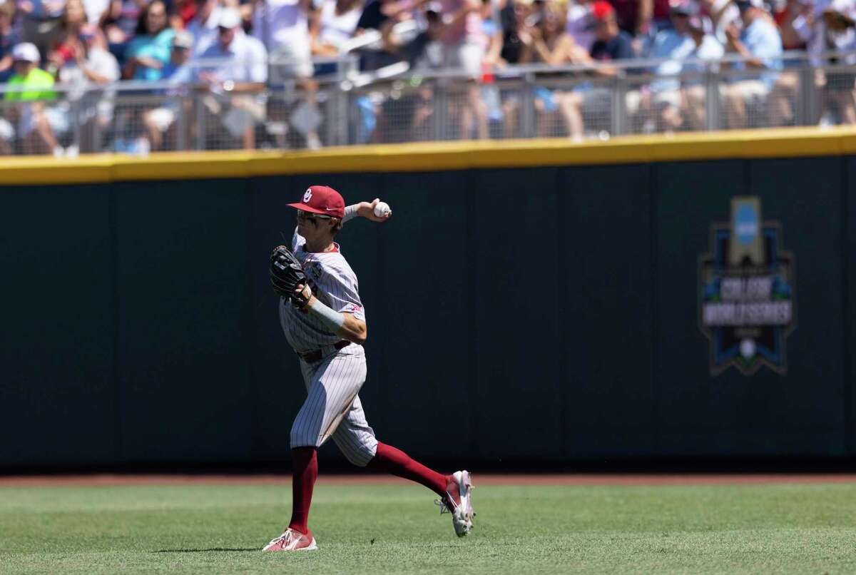 Oklahoma's John Spikerman fields a hit against Mississippi in Game 2 of the NCAA College World Series baseball finals, Sunday, June 26, 2022, in Omaha, Neb. (AP Photo/Rebecca S. Gratz)