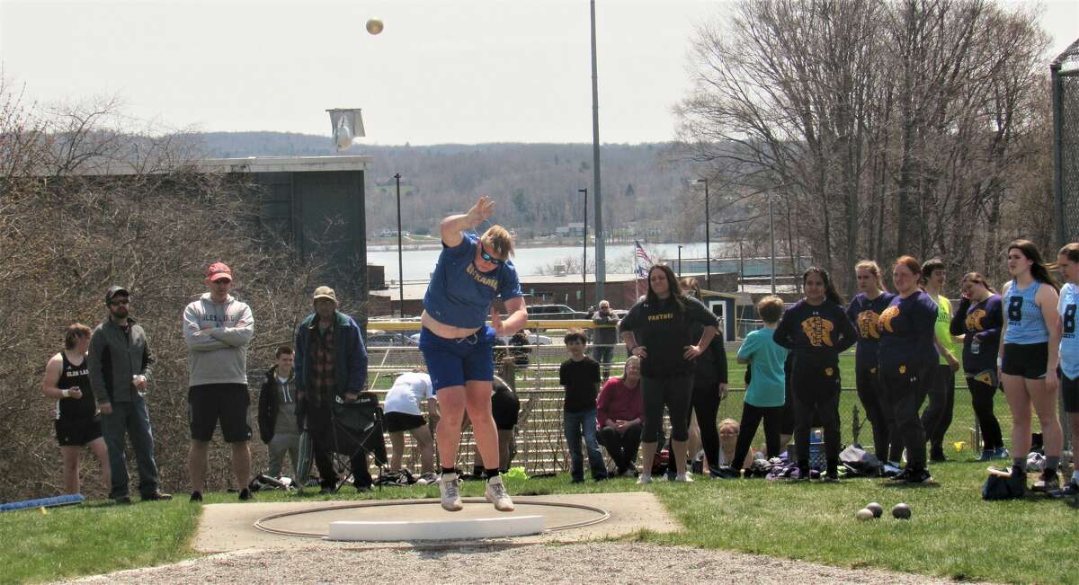 Onekama's Adam Domers hurls a warm-up throw during the shot put event at the Onekama Invite on April 29. 