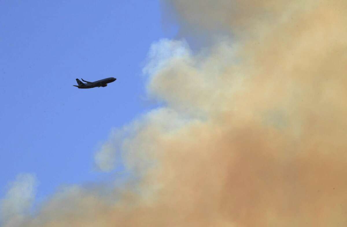 An air tanker approaches to drop retardant on the mountainside as the Rices Fire burned near French Corral, Calif., on Tuesday, June 28, 2022.