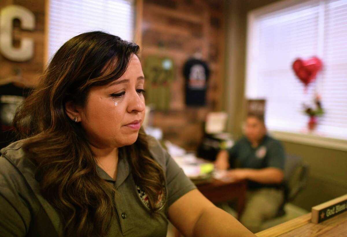 Rosie Torres weeps in 2019 as she describes how she watched her husband, Army veteran Le Roy Torres, in background, deteriorate after returning from Iraq. They learned Wednesday that the Supreme Court ruled in his favor in a lawsuit against his former employer, the Texas Department of Public Safety. Torres has trouble with his memory, perception and emotions, which he blames on exposure to toxic smoke from burn pits.