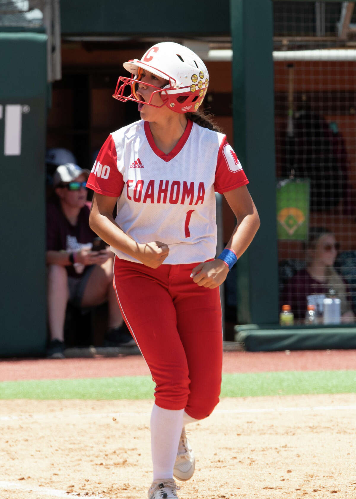 Coahoma catcher Karleigh Burt revs up the crowd after she drew a walk from the Hallettsville pitcher during the UIL Class 3A state softball championship game on June 2 in Austin. 