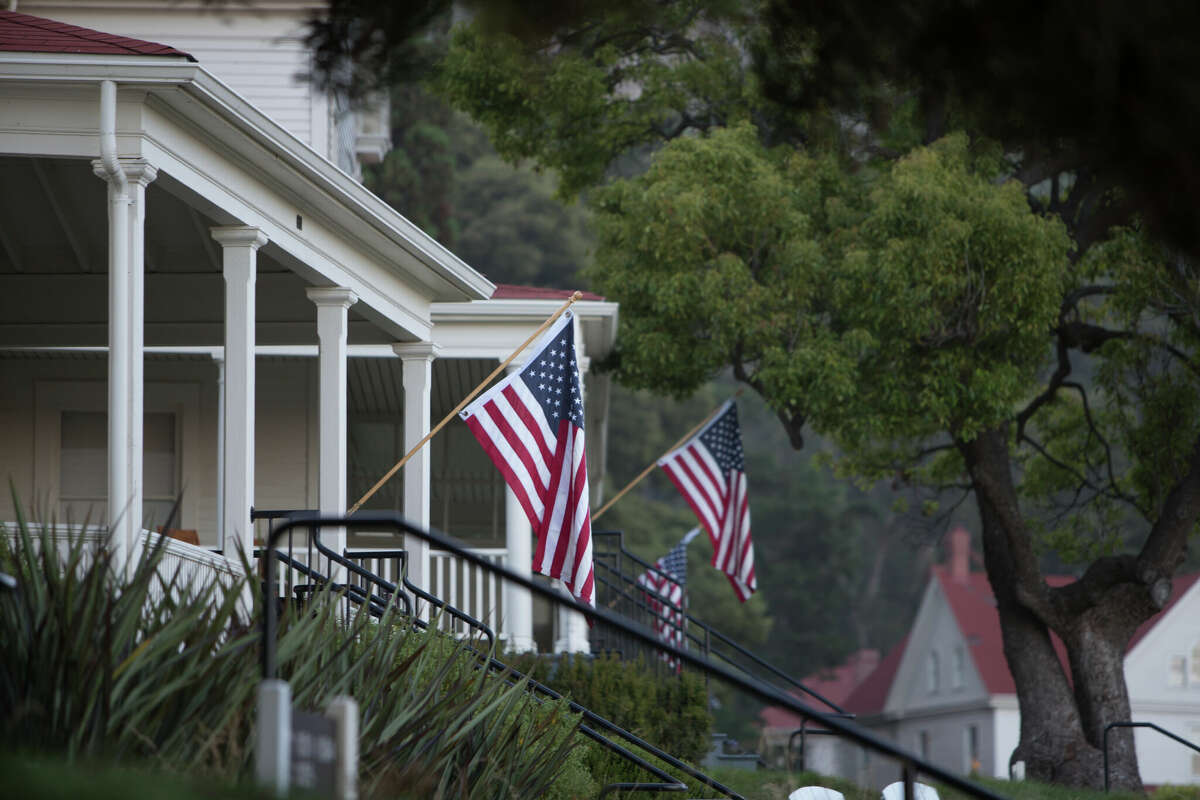 Below-normal temperatures are in the forecast for San Francisco over the Fourth of July holiday weekend. This file photo shows flags on the front porches of the homes at Fort Baker on July Fourth.