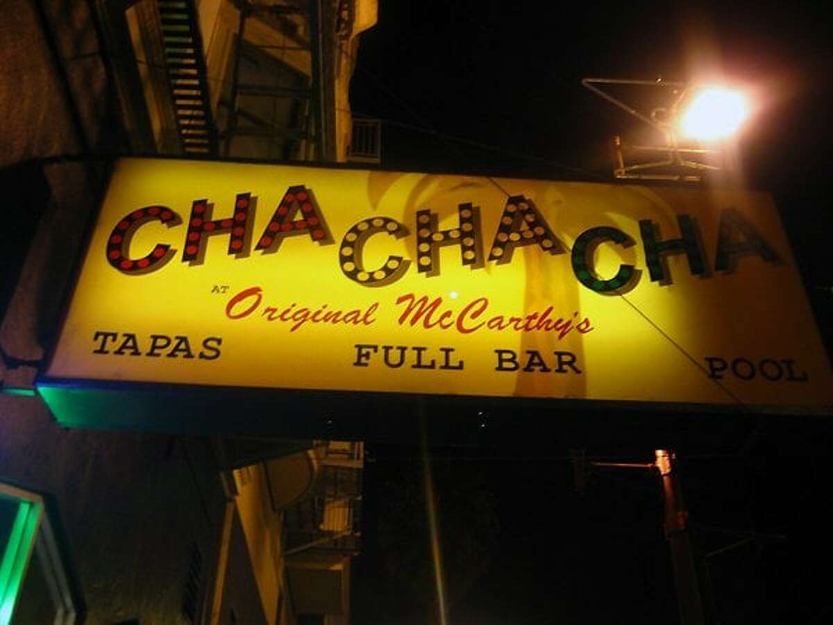 The Cha Cha Cha's sign on Mission Street glows in the night sky.