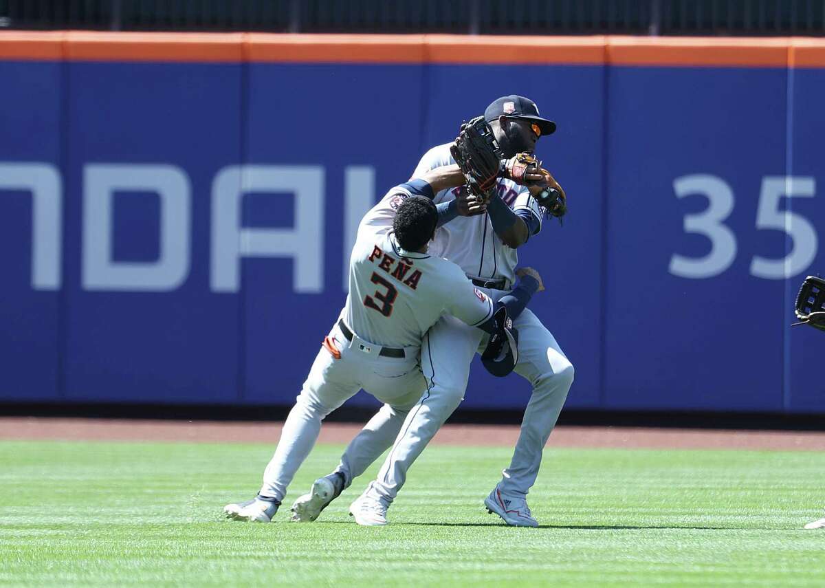 Astros shortstop Jeremy Peña, left, crashes into teammate Yordan Alvarez (44) during Wednesday's game against the Mets in New York.