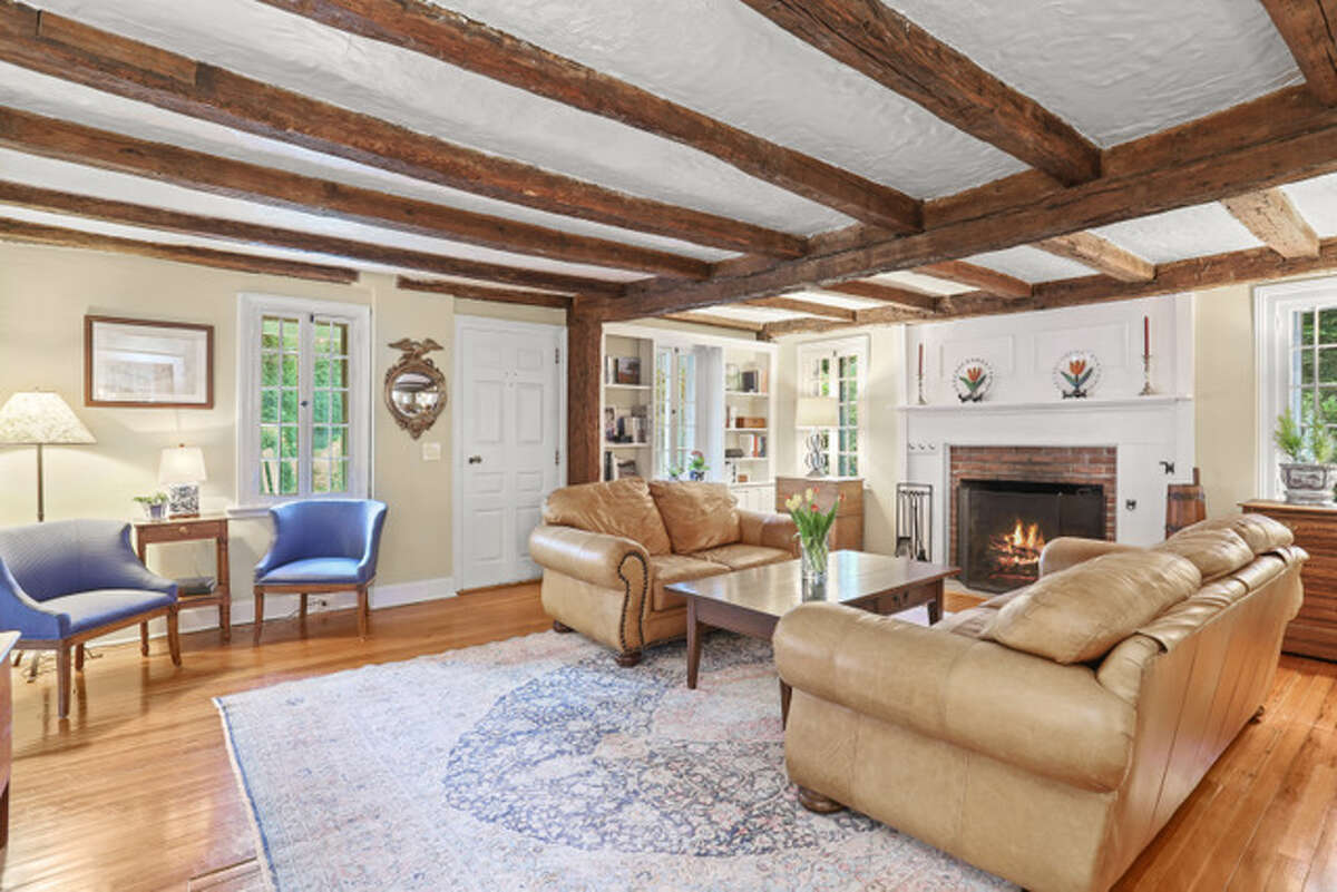 The living room in the home on 116 Murray Street in Norwalk, Conn. dates back to 1790 and features hand-hewn beams and hand-forged nails, as well as an original fireplace.